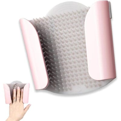 Wall-mounted silicone shower hair catcher installed on a tile shower wall