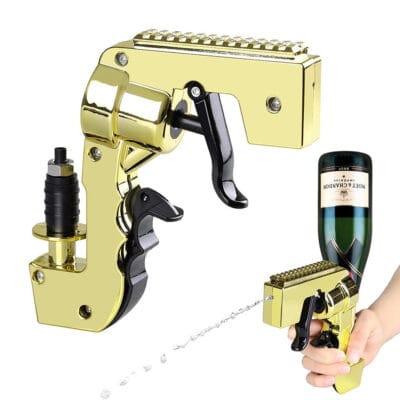 Golden champagne gun and ice bucket with beer bottles on a wooden table at outdoor party, people toasting in background, fun wine spray gun for celebrations, third generation beer shooter.